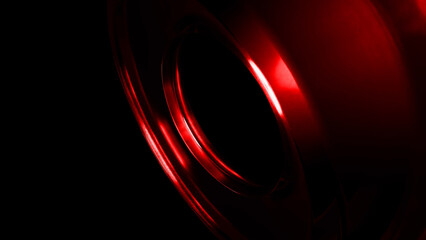 Smooth, red metallic curves create an abstract and modern design element, catching light and contrasting against a deep black background, suggesting elegance and sophistication