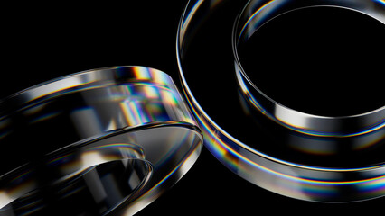Abstract glass rings with rainbow colored iridescence are intersecting and overlapping on a black background, creating a visually appealing composition