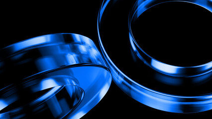 Two glossy blue metallic rings are rotating, creating an abstract composition against a dark...