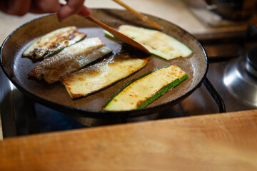 Cooked zucchini slices on plate in rustic home kitchen