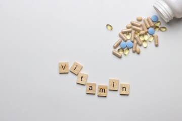 Vitamins pills and injectable in a white background