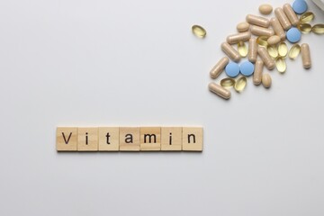 Vitamins pills and injectable in a white background