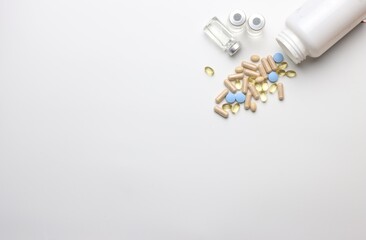 Vitamins pills and injectable in a white background