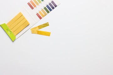 pH test strips in a white background with copy space