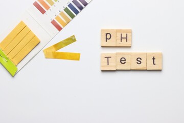 pH test strips in a white background with copy space