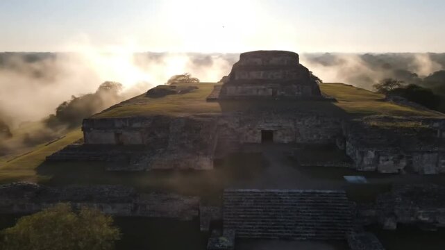 Misty morning sunrise over the ancient mayan ruins of ek balam, yucatan peninsula, mexico, showcasing the impressive stone structures emerging from the fog