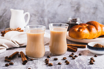 Yemeni coffee with cardamom, cinnamon and cream in glasses on table