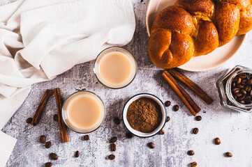 Yemeni coffee with cardamom, cinnamon and cream in glasses on table top view