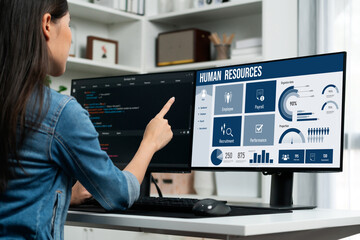 Human resources management software on computer screen helping human resources employee to manage...