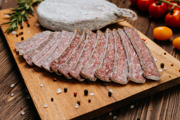 Dry-cured salami on board, ideal for rustic charcuterie presentations and gourmet food styling