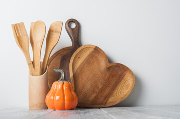 Autumn Kitchen Decor with Wooden Utensils and Ceramic Pumpkins