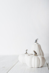 Minimalist White Pumpkins on White Wooden Background