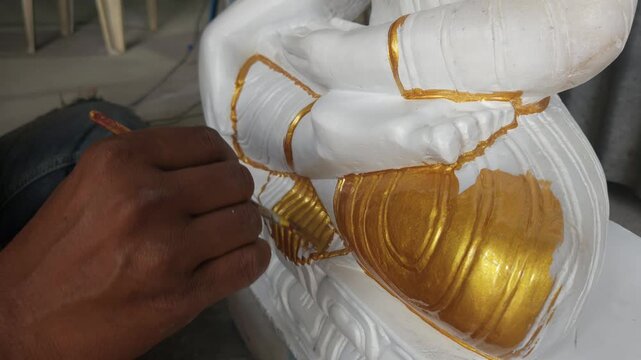 Indian artist doing paint on statue, Odisha, India