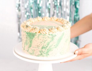 Peach and mint iced cake on a stand