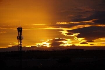 Telecommunication tower at sunset with dramatic sky
