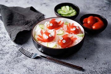 Rice noodles funchose with fresh tomatoes in the form of fishes in a bowl