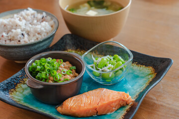 Traditional Japanese breakfast with grilled salmon, natto, miso soup and rice
