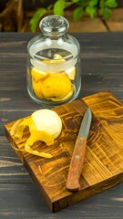 Peeled yellow fruit on a wooden cutting board