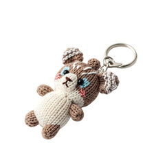 Naklejka premium A cute, handmade keychain featuring a small, brown and white bear with blue eyes and a smiling face. The bear is made of yarn and has a keyring attached.