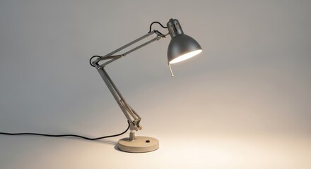 Illuminated vintage industrial metal desk lamp with an articulated arm.