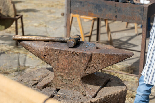 Hammer resting on anvil in blacksmith workshop