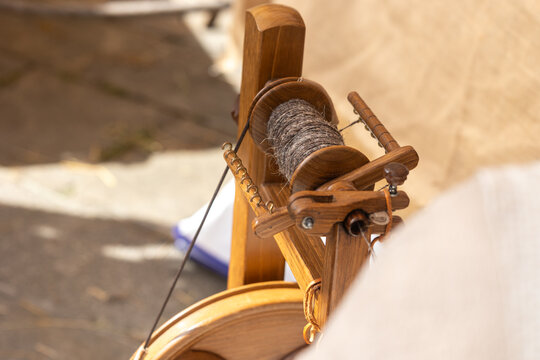 Traditional wooden spinning wheel winding wool yarn