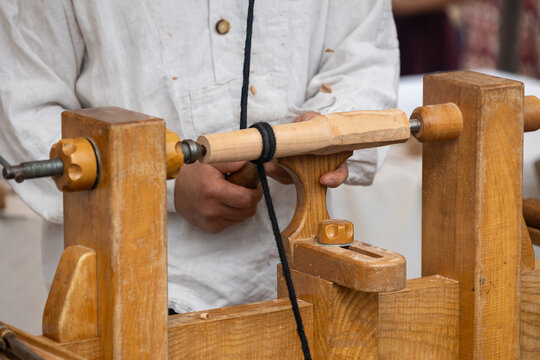 Carpenter using traditional pole lathe for woodworking