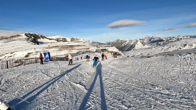 Skiers enjoying a sunny day on the slopes of grandvalira, andorra