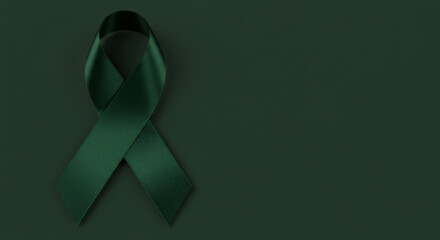 Dark green awareness ribbon on a matching background. Perfect for creating designs related to support, remembrance, or environmental causes