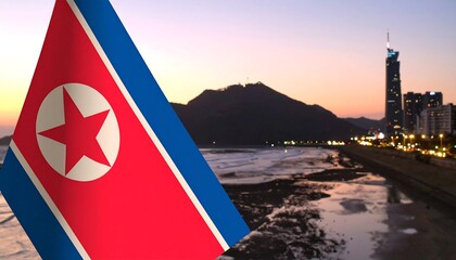 North Korean flag over a coastal city at dawn
