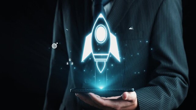 A businessman in a formal suit holds a smartphone displaying a vibrant rocket icon and various digital symbols, symbolizing innovation, growth, and the startup journey. Qubit