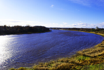 River with a turn and a pitchfork on a fortress, wildlife, background.