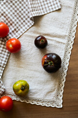 Multicolored tomatoes on the table top view indoors in autumn