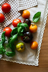 Multicolored tomatoes on the table top view indoors in autumn
