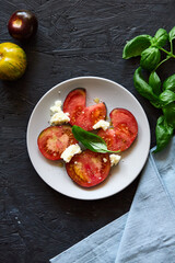 Red farm tomatoes on a plate top view