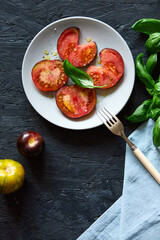 Red farm tomatoes on a plate top view