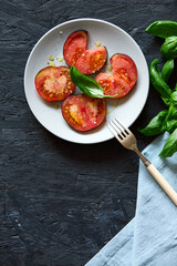 Red farm tomatoes on a plate top view