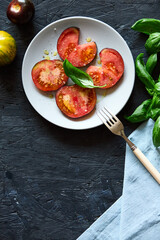 Red farm tomatoes on a plate top view