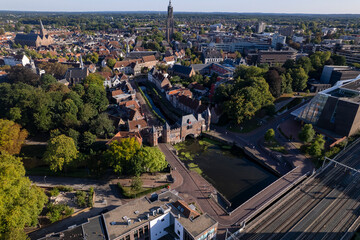 Aerial view of double gated medieval city entrance Koppelpoort structure in Amersfoort, The Netherlands, with the historic urban city center in the background