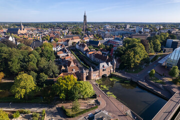 Aerial view of double gated medieval city entrance Koppelpoort structure in Amersfoort, The Netherlands, with the historic urban city center in the background