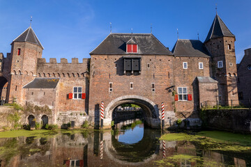 Aerial closeup view looking up at historic double entry gate Koppelpoort in Dutch cultural heritage site in Amersfoort, The Netherlands, seen from the moat Rijn canal access to the medieval city