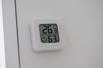 Close-up of White Thermometer and Hygrometer on a White Desk