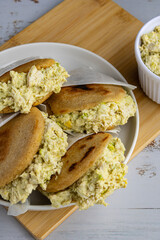 Venezuelan arepa Reina Pepiada stuffed with shredded chicken and creamy avocado. Authentic Latin street food with traditional homemade flavor