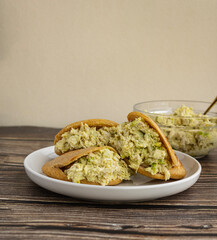 Venezuelan arepa Reina Pepiada stuffed with shredded chicken and creamy avocado. Authentic Latin street food with traditional homemade flavor