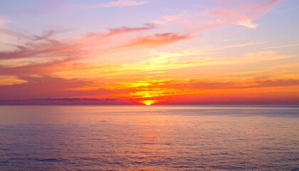 Naklejka premium A spectacular sunset over the tranquil sea, painting the sky with a seamless gradient of fiery orange and soft pink clouds