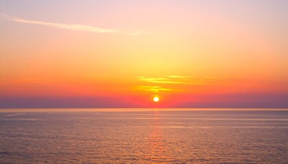 Fototapeta premium Vivid sunset sky with a seamless gradient from deep orange to soft pink over the calm ocean horizon