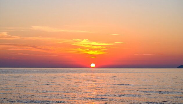 A vivid sunset sky displaying a beautiful gradient from deep orange to soft pink, reflecting on the tranquil ocean as the sun meets the horizon - Powered by Adobe