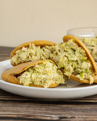 Venezuelan arepa Reina Pepiada stuffed with shredded chicken and creamy avocado. Authentic Latin street food with traditional homemade flavor