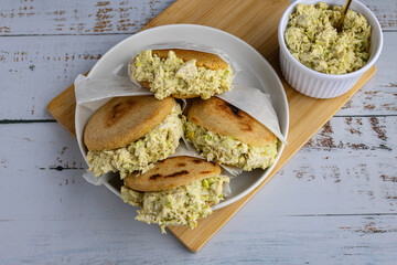 Venezuelan arepa Reina Pepiada stuffed with shredded chicken and creamy avocado. Authentic Latin street food with traditional homemade flavor