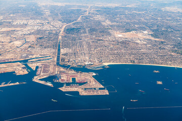 Aerial view of the Port of Long Beach, California, showcasing the expansive port infrastructure with numerous shipping containers and cranes. 
